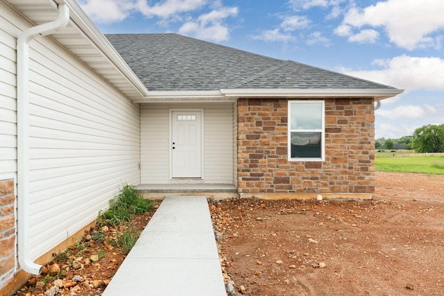 1312 N Maxine Ave, Nixa, MO 65714 - doorway to property featuring roof with shingles and stone siding