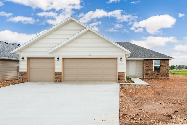 1312 N Maxine Ave, Nixa, MO 65714 - view of front of property with driveway, a garage, and a shingled roof