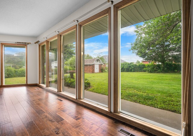 1622 Oakland Ave, Bolivar, MO 65613 - unfurnished sunroom featuring wood-type flooring
