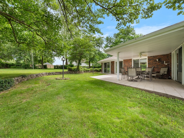 1622 Oakland Ave, Bolivar, MO 65613 - view of grassy yard featuring ceiling fan and a patio area