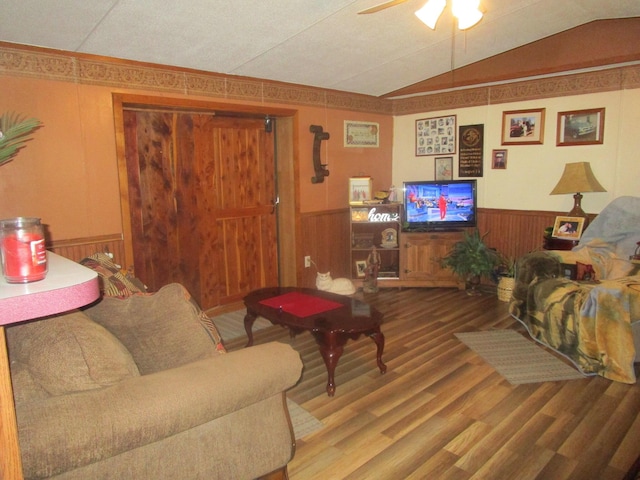 9065 County Road 3940, Mountain View, MO 65548 - living area with a wainscoted wall, vaulted ceiling, wood finished floors, a ceiling fan, and wood walls