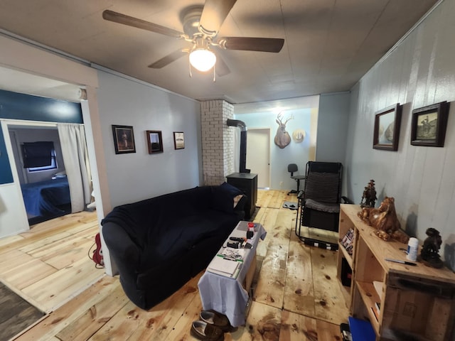 626 W N St, Mountain Grove, MO 65711 - living area with hardwood / wood-style flooring, ceiling fan, and a wood stove