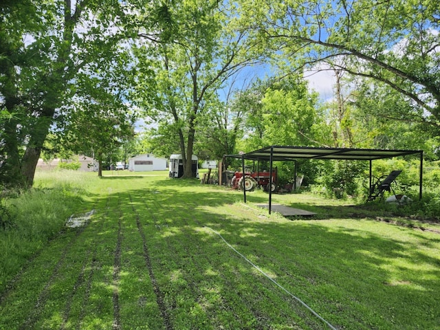 626 W N St, Mountain Grove, MO 65711 - view of grassy yard with a detached carport
