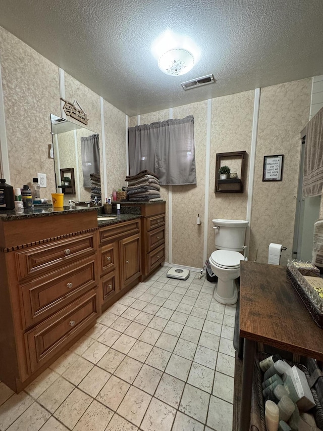 11513 Co Rd Unit 76-203, Ava, MO 65608 - full bath with vanity, a textured ceiling, toilet, tile patterned flooring, and wallpapered walls