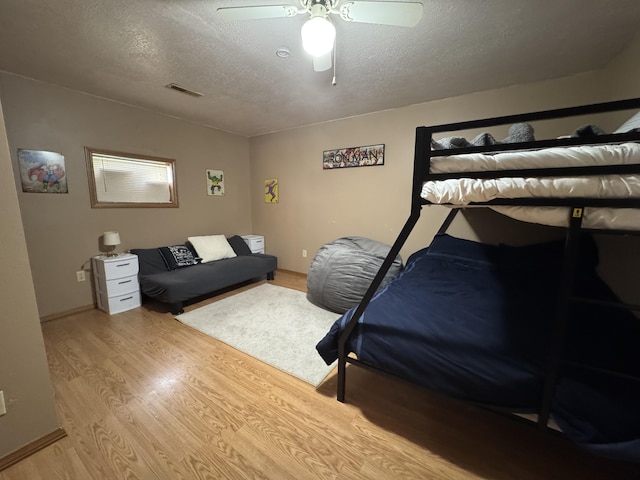 11513 Co Rd Unit 76-203, Ava, MO 65608 - bedroom featuring a textured ceiling, light wood-style floors, and a ceiling fan