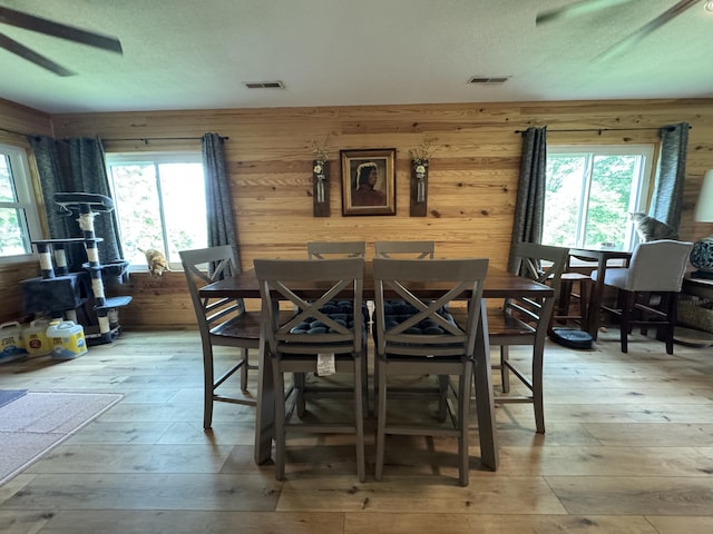 11513 Co Rd Unit 76-203, Ava, MO 65608 - dining area with a ceiling fan, light wood-style floors, plenty of natural light, and wood walls
