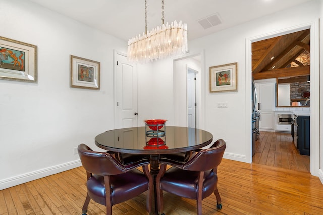 185 Appaloosa Trl, Saddlebrooke, MO 65630 - dining room featuring light wood-style floors, a chandelier, and baseboards