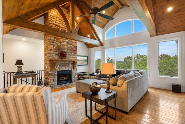 185 Appaloosa Trl, Saddlebrooke, MO 65630 - living area with high vaulted ceiling, hardwood / wood-style floors, ceiling fan, a fireplace, and wooden ceiling with exposed beams