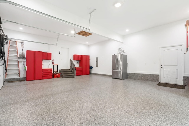 185 Appaloosa Trl, Saddlebrooke, MO 65630 - garage featuring freestanding refrigerator, electric panel, recessed lighting, and baseboards