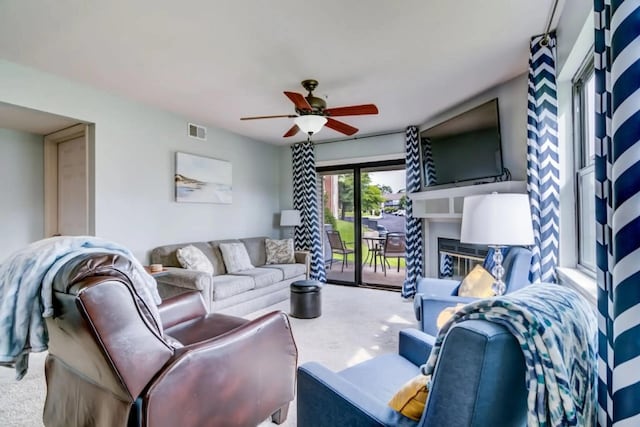 123 Bunker Ridge Dr Unit 4, Branson, MO 65616 - living area with carpet, a glass covered fireplace, and ceiling fan