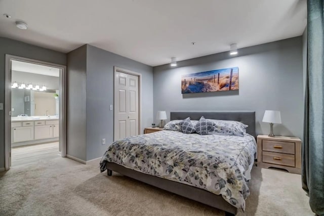 123 Bunker Ridge Dr Unit 4, Branson, MO 65616 - bedroom with light colored carpet, baseboards, connected bathroom, and a closet