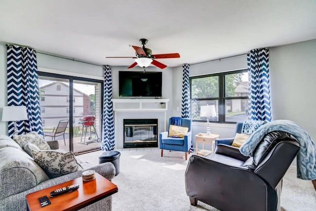 123 Bunker Ridge Dr Unit 4, Branson, MO 65616 - carpeted living room with healthy amount of natural light, a ceiling fan, and a glass covered fireplace
