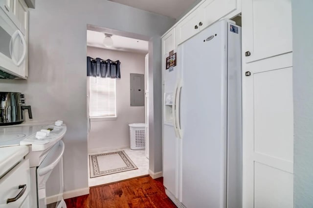 123 Bunker Ridge Dr Unit 4, Branson, MO 65616 - kitchen featuring white appliances, electric panel, white cabinets, dark wood-style floors, and light countertops