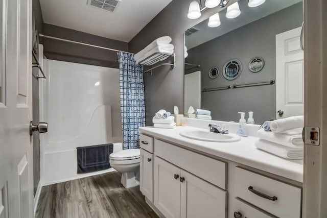 123 Bunker Ridge Dr Unit 4, Branson, MO 65616 - full bathroom with toilet, vanity, shower / tub combo with curtain, and wood finished floors