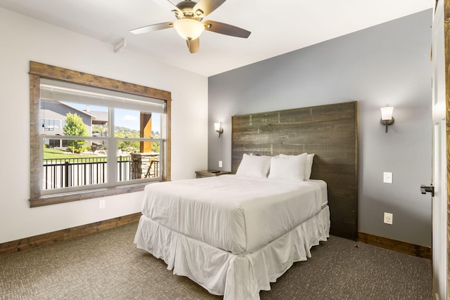 carpeted bedroom with baseboards and a ceiling fan