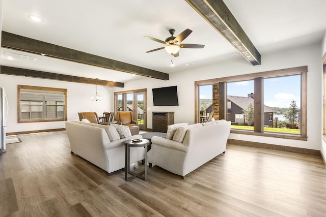 living area featuring beam ceiling, wood finished floors, a ceiling fan, baseboards, and recessed lighting