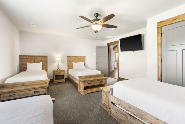 bedroom with dark colored carpet and a ceiling fan