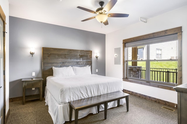 bedroom featuring electric panel, carpet flooring, and baseboards