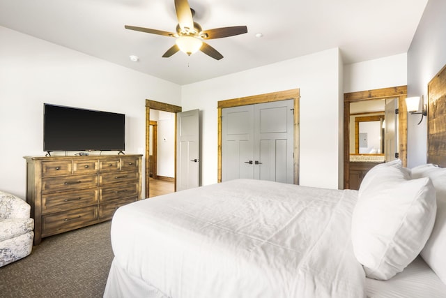 carpeted bedroom featuring ceiling fan and ensuite bath