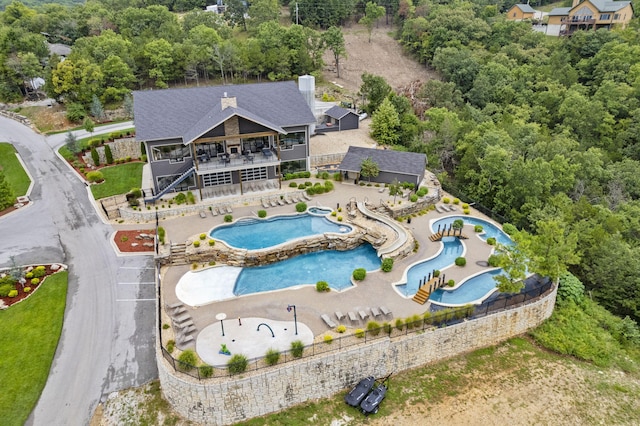 aerial view of property and surrounding area with a pool