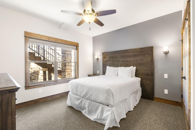 carpeted bedroom featuring baseboards and ceiling fan
