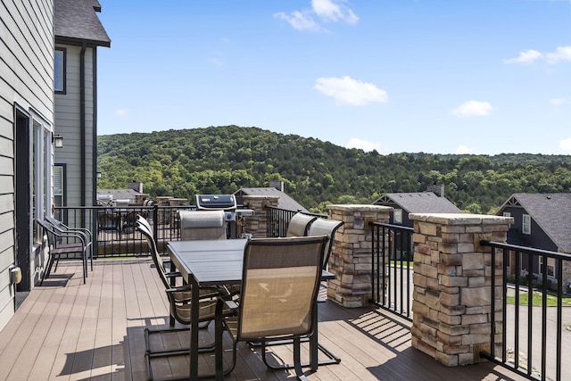 wooden deck with a view of trees