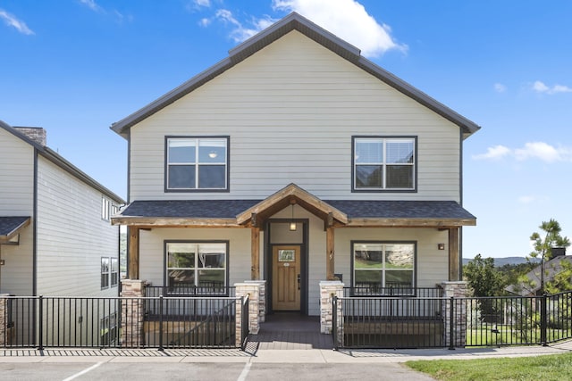 view of front of property with a porch and a shingled roof