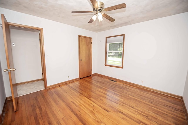 202 E Seminole St, Springfield, MO 65807 - unfurnished room with hardwood / wood-style flooring, baseboards, and ceiling fan