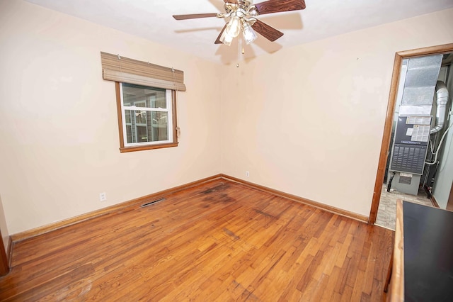 202 E Seminole St, Springfield, MO 65807 - unfurnished room with hardwood / wood-style flooring, a ceiling fan, and baseboards