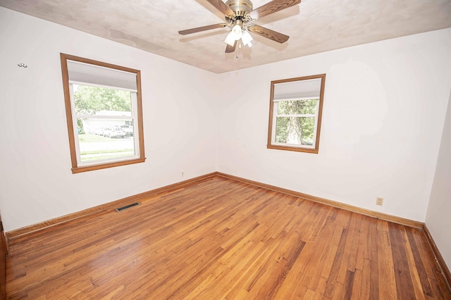 202 E Seminole St, Springfield, MO 65807 - empty room featuring hardwood / wood-style flooring, baseboards, and ceiling fan