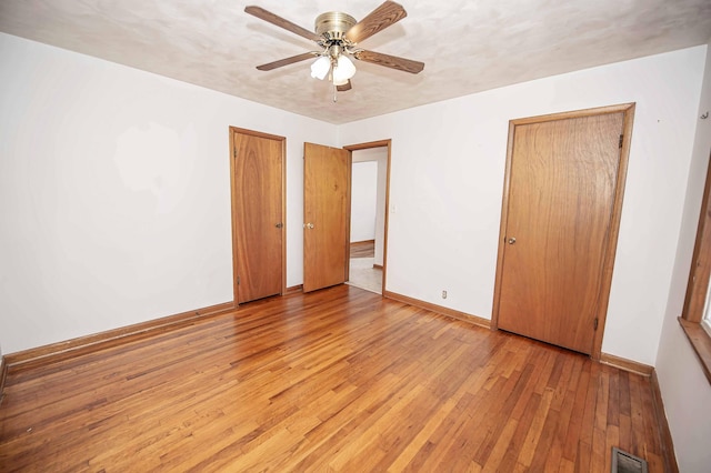 202 E Seminole St, Springfield, MO 65807 - unfurnished bedroom featuring light wood-style flooring, baseboards, and a ceiling fan