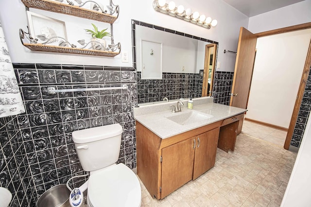 202 E Seminole St, Springfield, MO 65807 - bathroom with tile walls, toilet, vanity, and wainscoting