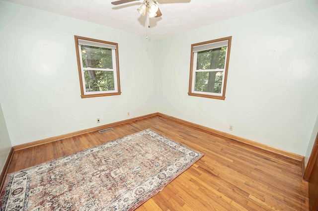 202 E Seminole St, Springfield, MO 65807 - empty room featuring hardwood / wood-style flooring, plenty of natural light, and ceiling fan