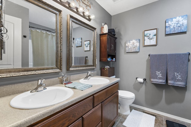 1206 S Solaira St, Ozark, MO 65721 - full bathroom featuring double vanity, toilet, and baseboards