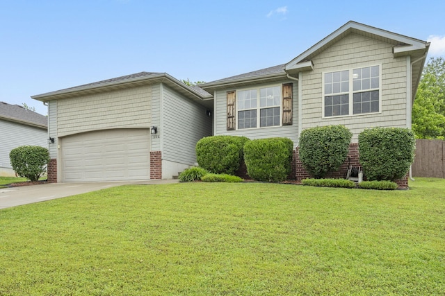 1206 S Solaira St, Ozark, MO 65721 - view of front of house with an attached garage, concrete driveway, a front yard, and brick siding