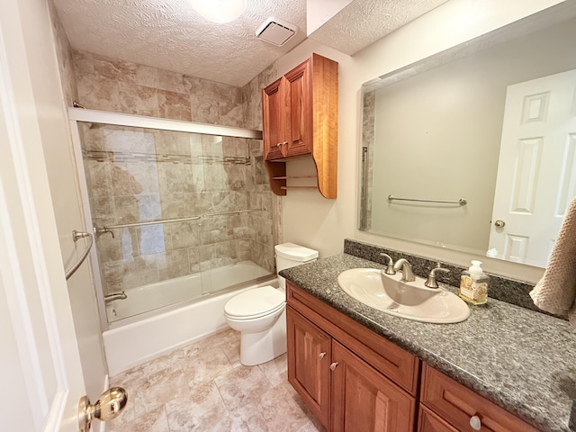 5135 S Clay Ave, Springfield, MO 65810 - full bathroom featuring vanity, toilet, a textured ceiling, and shower / bath combination with glass door