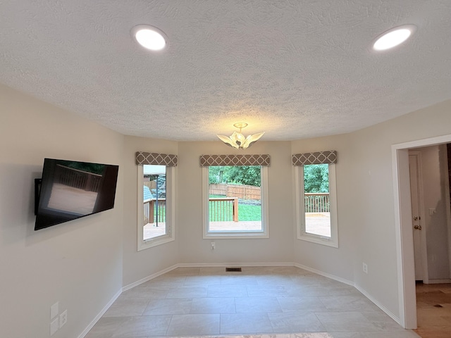 5135 S Clay Ave, Springfield, MO 65810 - spare room featuring a textured ceiling, baseboards, and recessed lighting