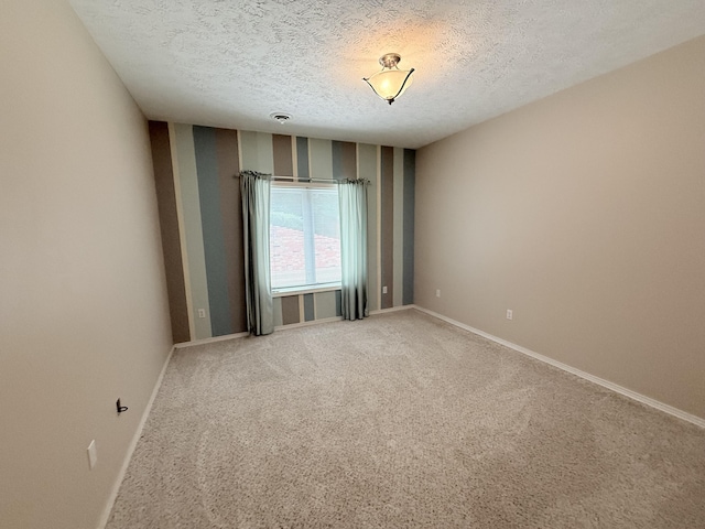5135 S Clay Ave, Springfield, MO 65810 - spare room with a textured ceiling, baseboards, light colored carpet, and wallpapered walls
