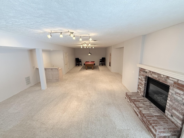 5135 S Clay Ave, Springfield, MO 65810 - unfurnished living room featuring light colored carpet, a fireplace, a textured ceiling, and pool table