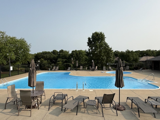 5135 S Clay Ave, Springfield, MO 65810 - community pool with a patio and view of wooded area