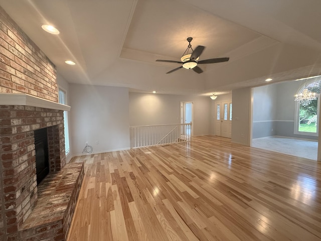 5135 S Clay Ave, Springfield, MO 65810 - unfurnished living room with a raised ceiling, wood finished floors, a brick fireplace, a chandelier, and recessed lighting