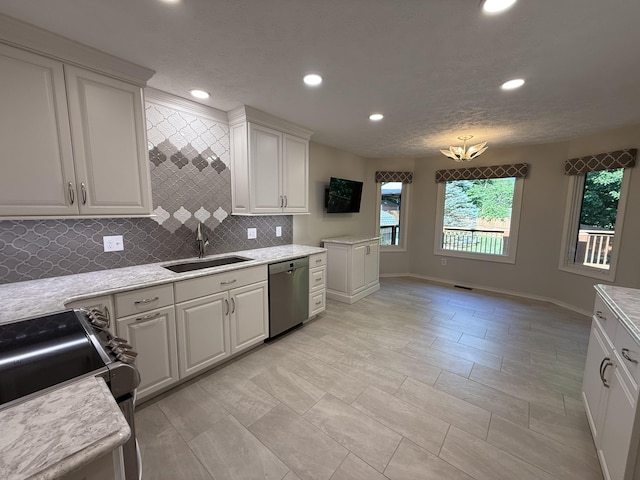 5135 S Clay Ave, Springfield, MO 65810 - kitchen featuring stainless steel appliances, a sink, recessed lighting, tasteful backsplash, and light countertops