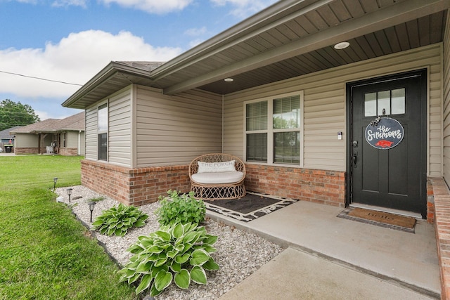 1054 Thoroughfare St, Seymour, MO 65746 - view of exterior entry with brick siding and a lawn