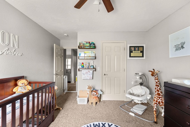 1054 Thoroughfare St, Seymour, MO 65746 - bedroom featuring carpet floors, a crib, and ceiling fan