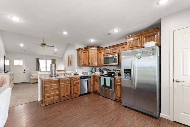 1054 Thoroughfare St, Seymour, MO 65746 - kitchen with appliances with stainless steel finishes, brown cabinetry, open floor plan, a sink, and a peninsula