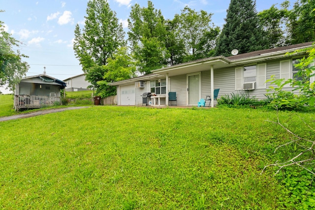 1408 Rockhill Cir, Ozark, MO 65721 - back of property with an attached garage, a yard, asphalt driveway, and cooling unit