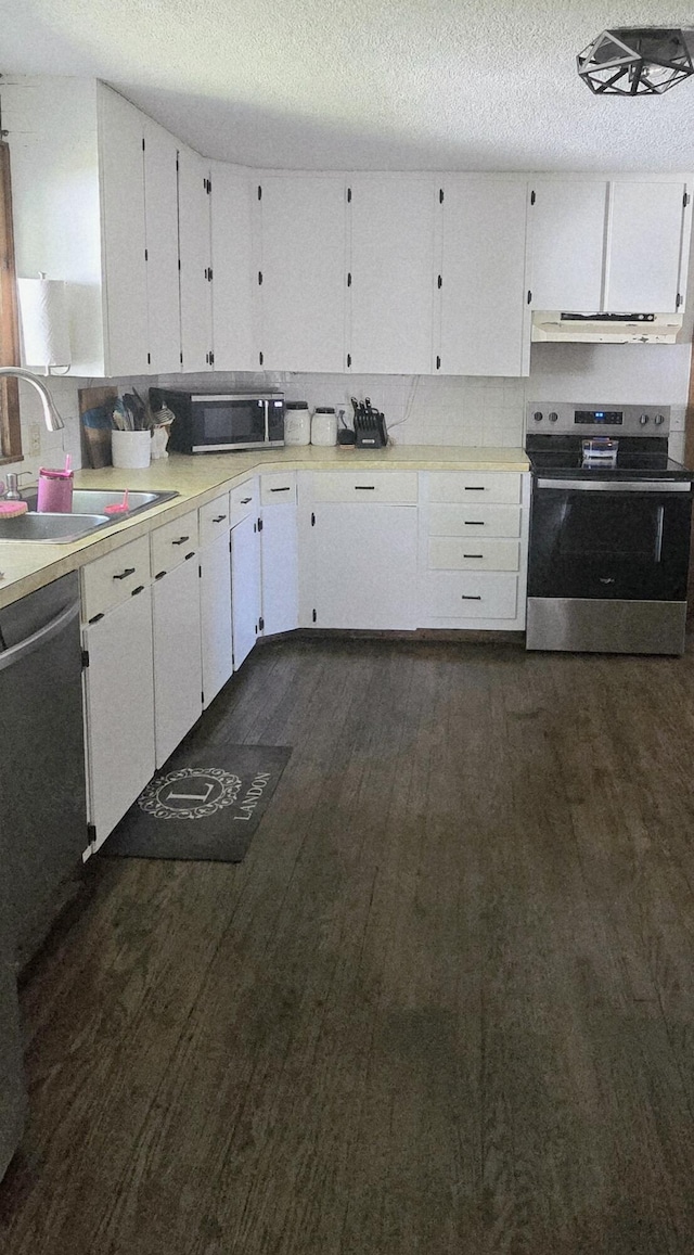 414 3rd St, Anderson, MO 64831 - kitchen with stainless steel appliances, a sink, white cabinetry, a textured ceiling, and light countertops
