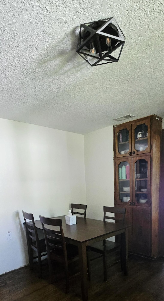 414 3rd St, Anderson, MO 64831 - dining space with wood finished floors and a textured ceiling
