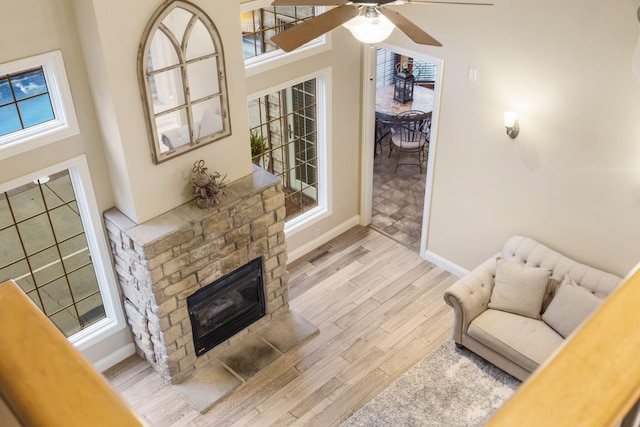 2421 Candlebark Ln, Lebanon, MO 65536 - living area featuring light wood-type flooring, a ceiling fan, and a fireplace