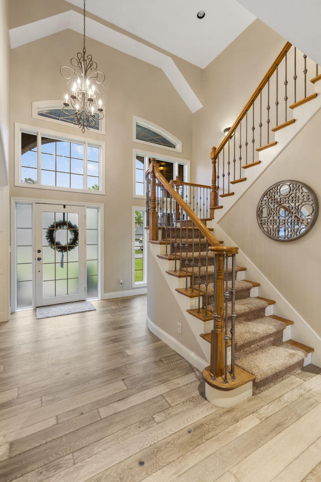 2421 Candlebark Ln, Lebanon, MO 65536 - foyer entrance with high vaulted ceiling, wood finished floors, stairs, and a chandelier